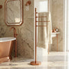 Tribecca Collection Freestanding 49 Inch 4 Pivoting Swing Arm Towel Valet shown in the Brushed Bronze finish in a bathroom setting